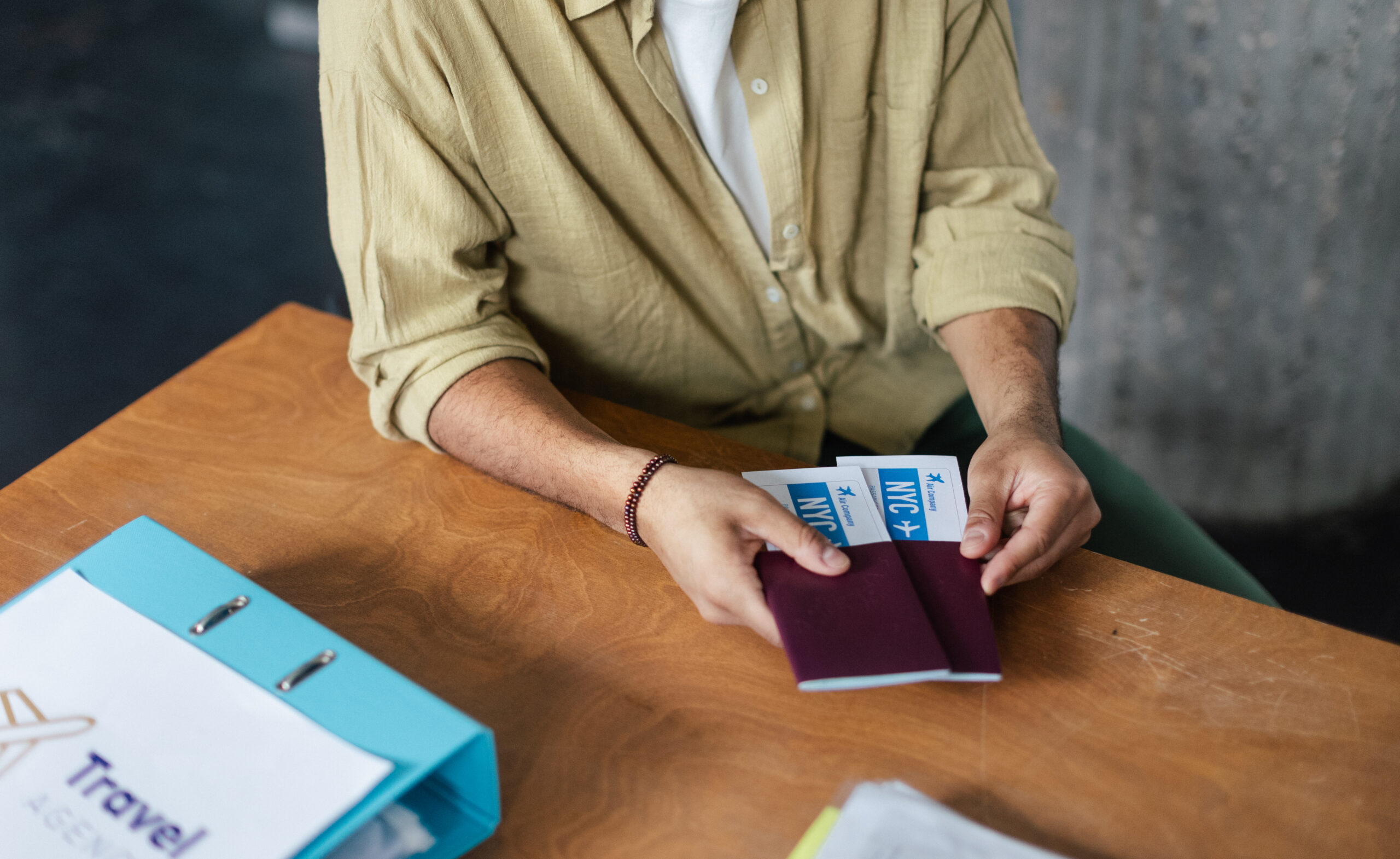 Close up of young woman holding plane tickets.