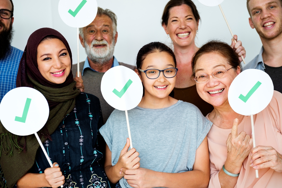 Group of diverse people showing right mark boards